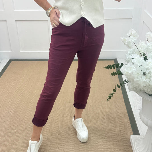 Marnie: Stretchy burgundy magic trousers with rear pockets. 3 Sizes: 10-22