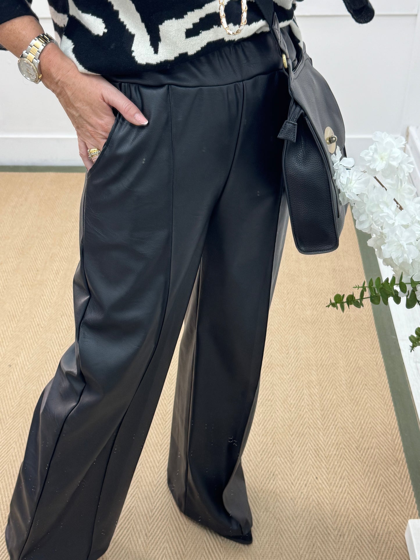 Tabatha: Black faux leather trousers. One size: 12-16