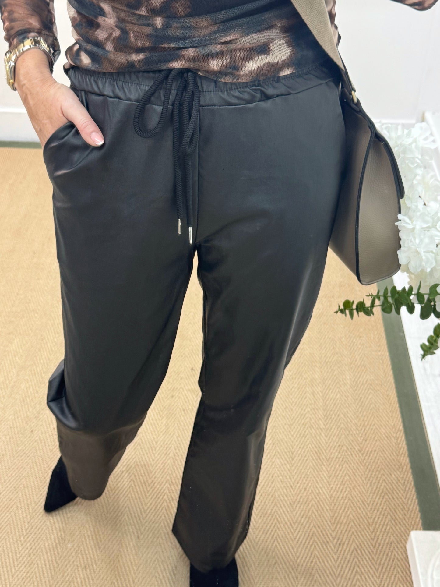 Quinn: Black faux leather trousers. One size: 10-14