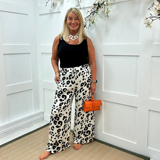 Dakota: White leopard print wide leg silky trousers. One size: 10-18