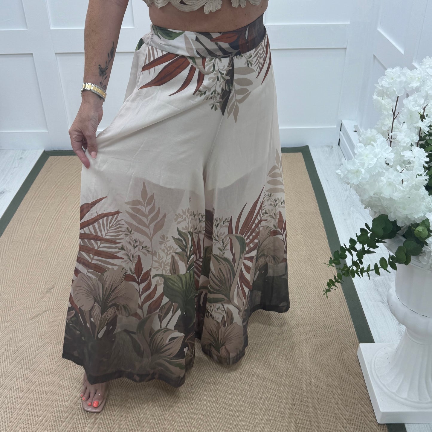 Lyra: Cream tropical print wide leg sheer trousers. One size: 8-14