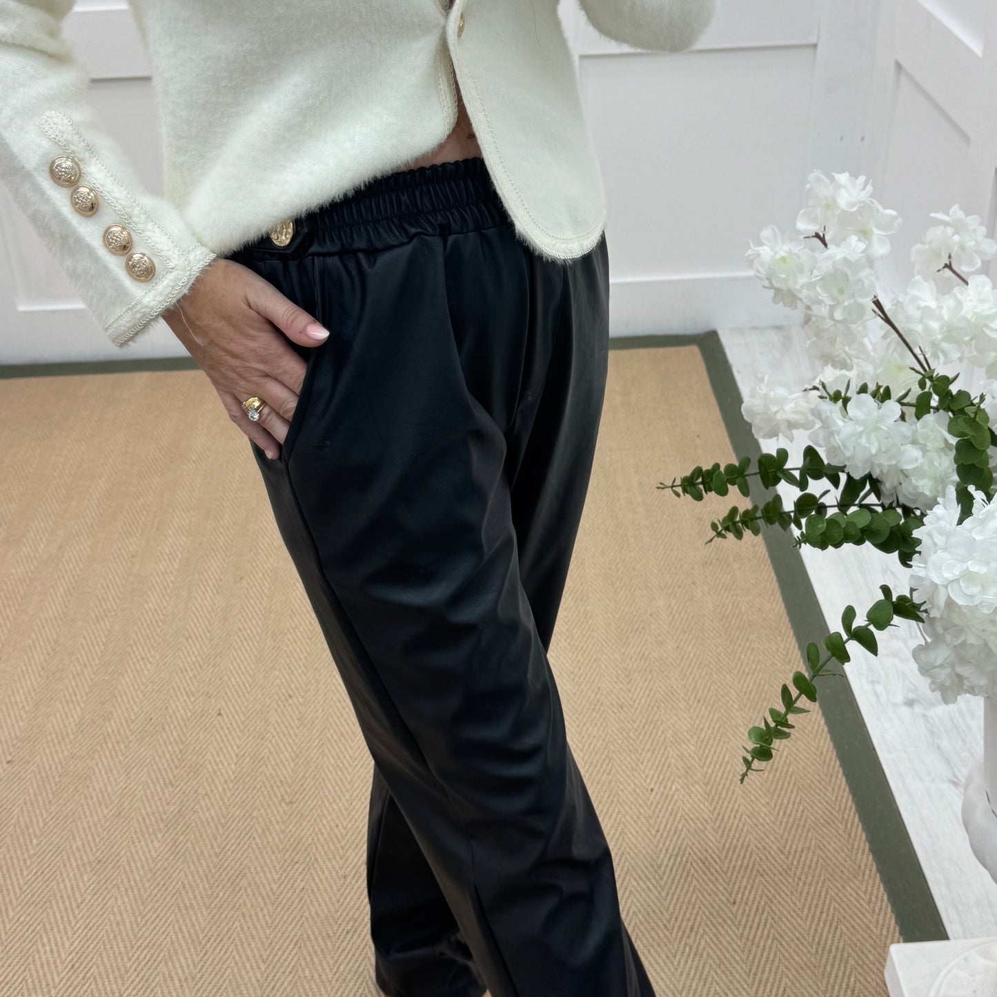 Tatum: Black faux leather button trousers. One size: 14-18