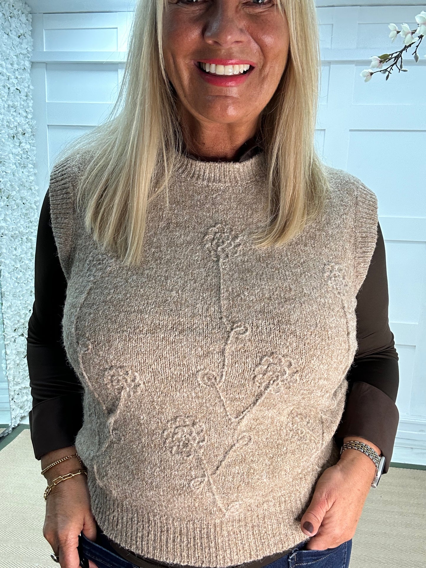 Larry: Beige sleeveless tank top with flower detail. One Sz: 12-18