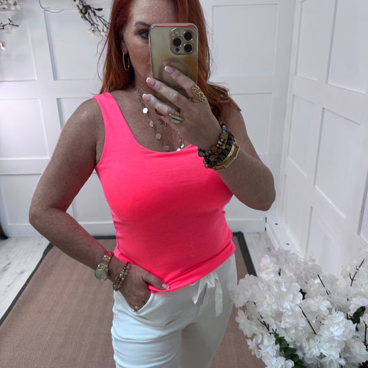 Abigail: Stretchy basic neon pink vest top. 2 sizes