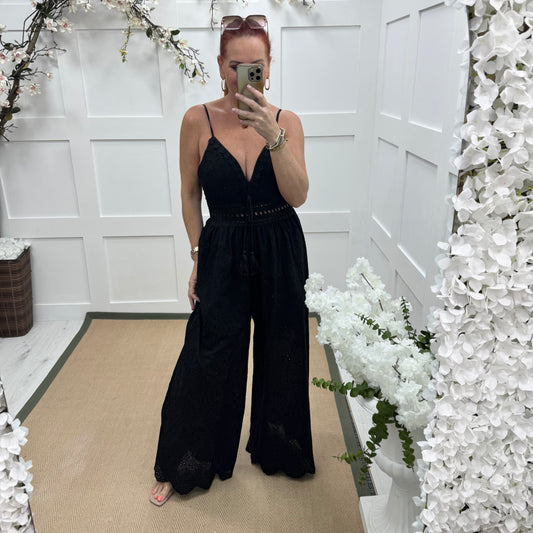 Bria: Black broderie Anglaise strappy jumpsuit. One size: 10-14