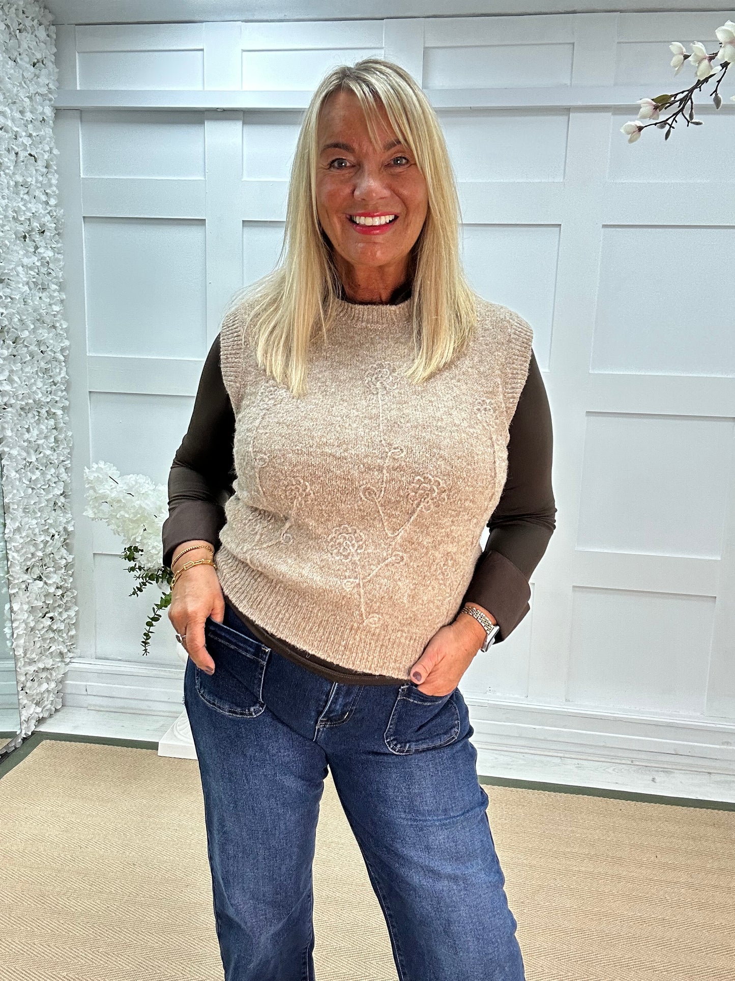 Larry: Beige sleeveless tank top with flower detail. One Sz: 12-18