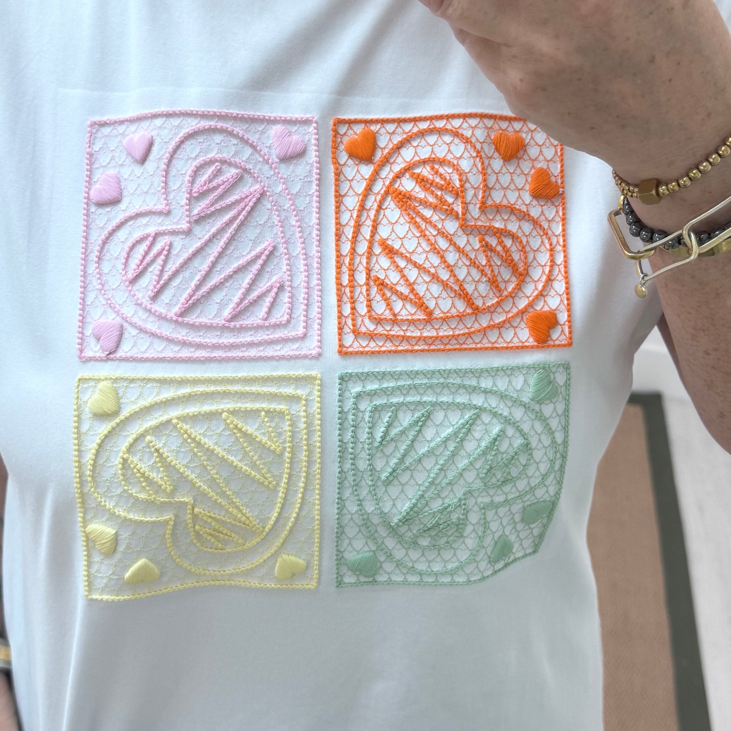 Sophie: White embroidered orange heart T shirt. One size 14-18