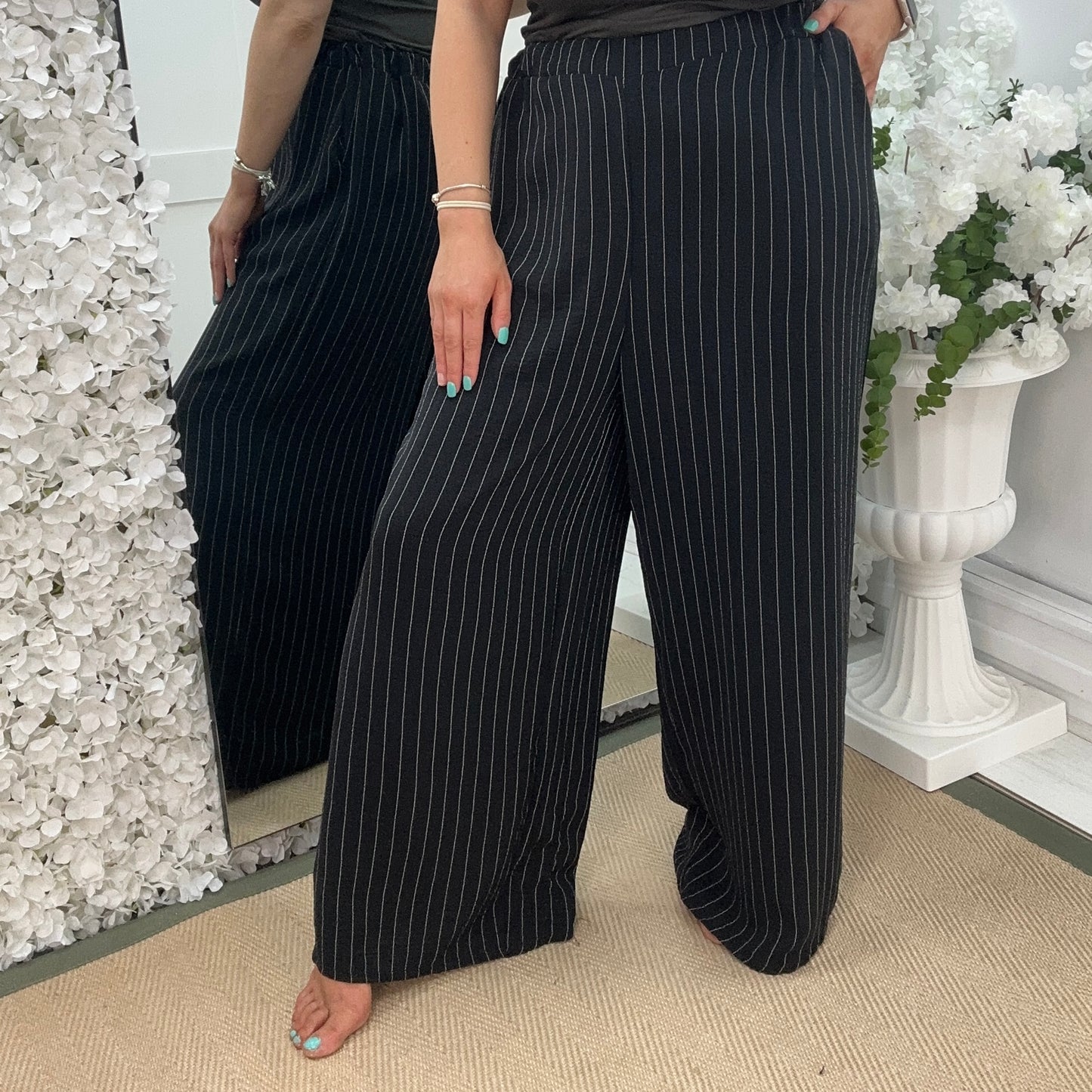 Storm: Black pinstripe wide leg trousers. One size: 16-22