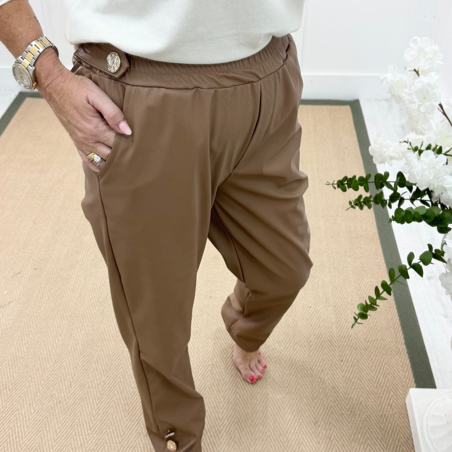 Tatum: Coffee faux leather button trousers. One size: 14-18