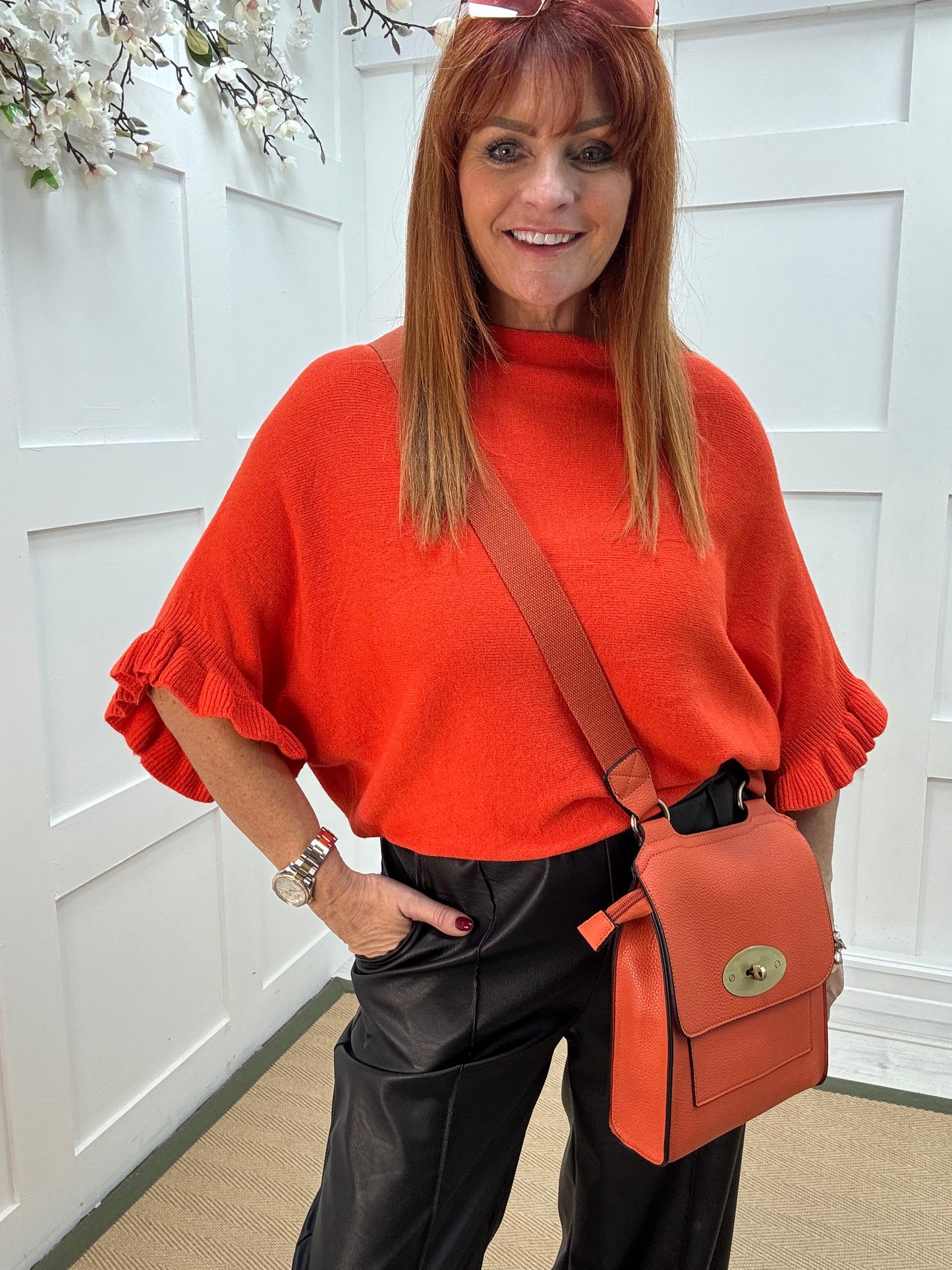 Sierra: Orange batwing fluted sleeve knitted top. One Size 12-18/20