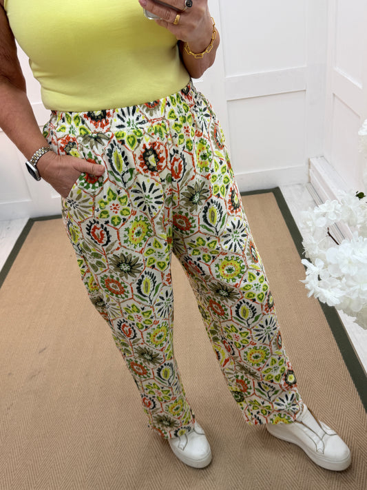 Tilly: Green geometric print wide leg trousers. One size: 12-18