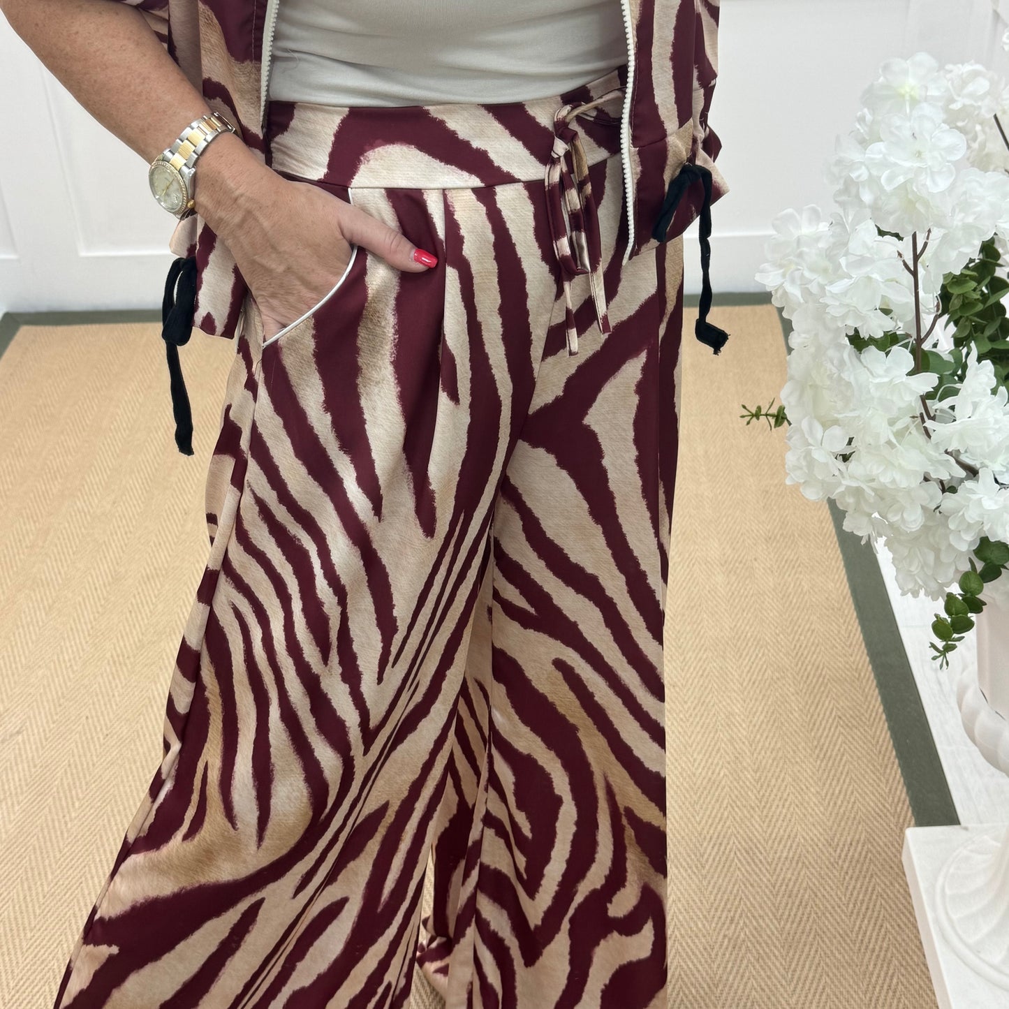 Aven: Burgundy zebra print wide leg trousers. One size: 10-16