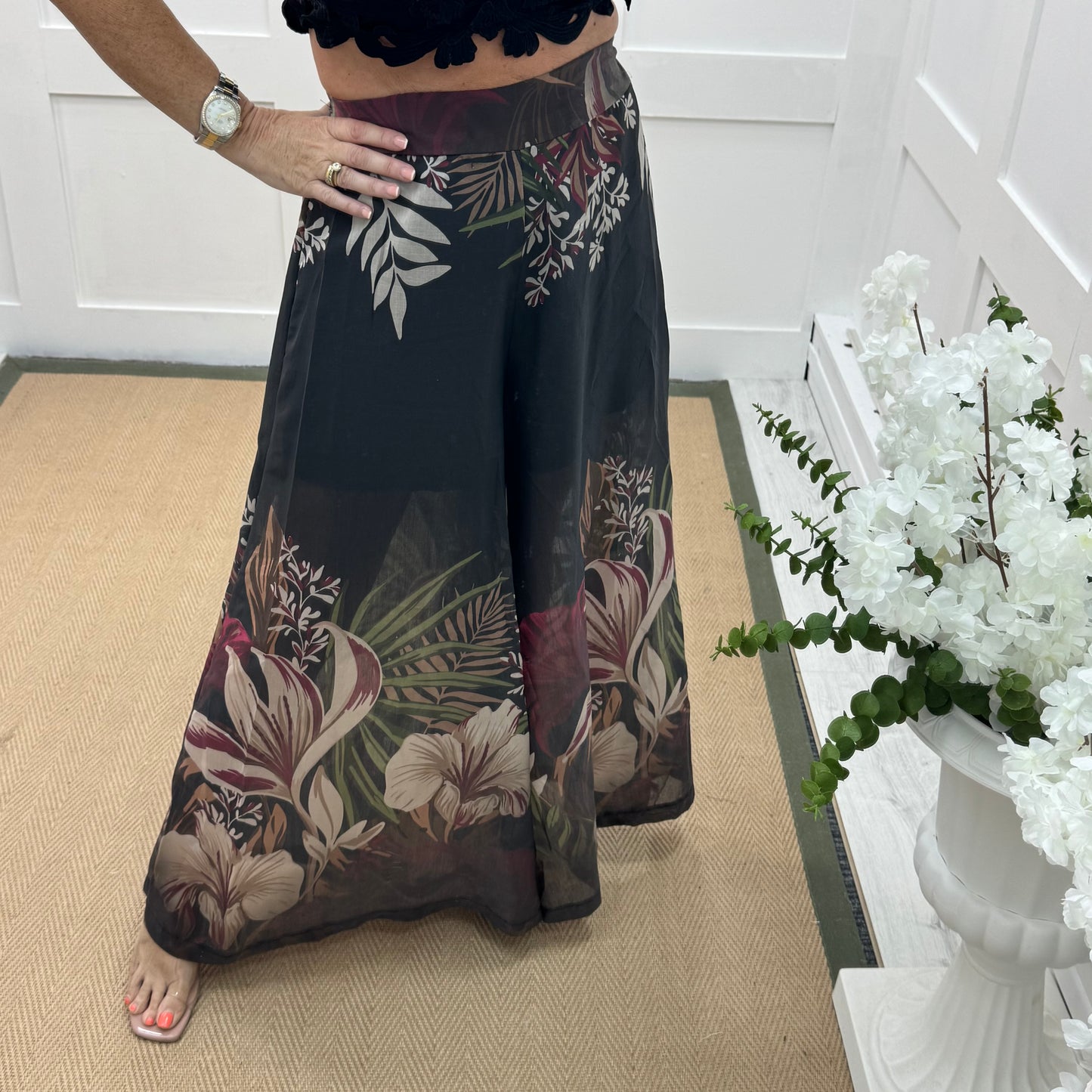 Lyra: Black tropical print wide leg sheer trousers. One size: 8-14