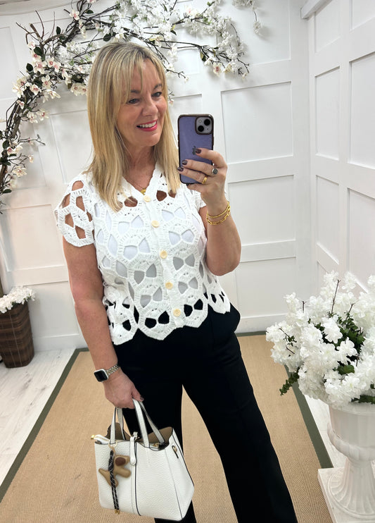 Cara: White V neck crochet top. One size: 12-16