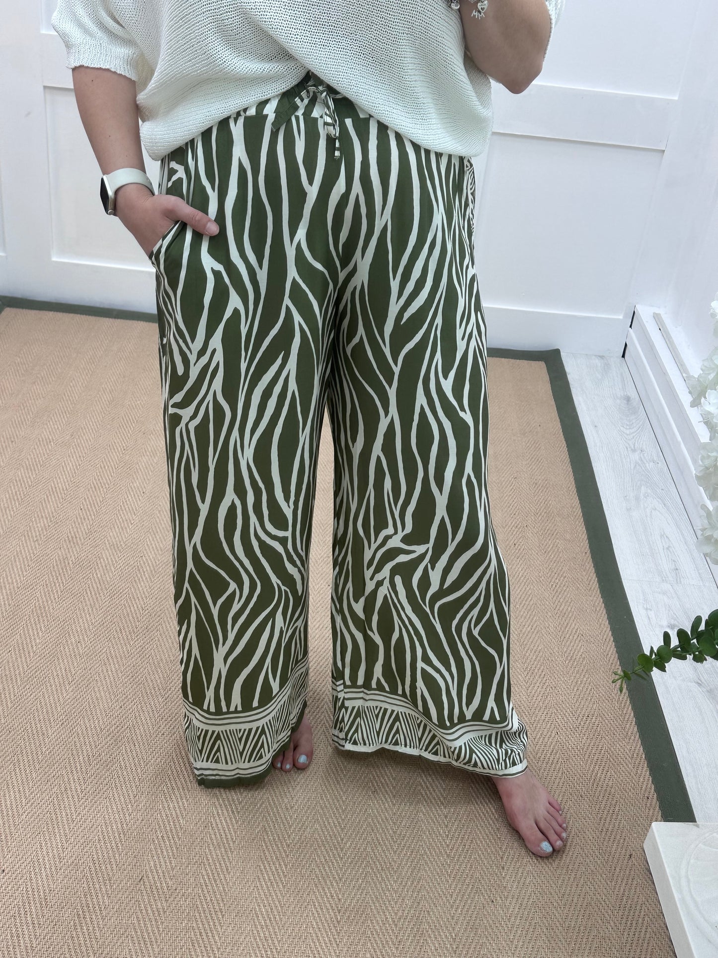 Skye: Khaki zebra print wide leg trousers. One size: 10-16