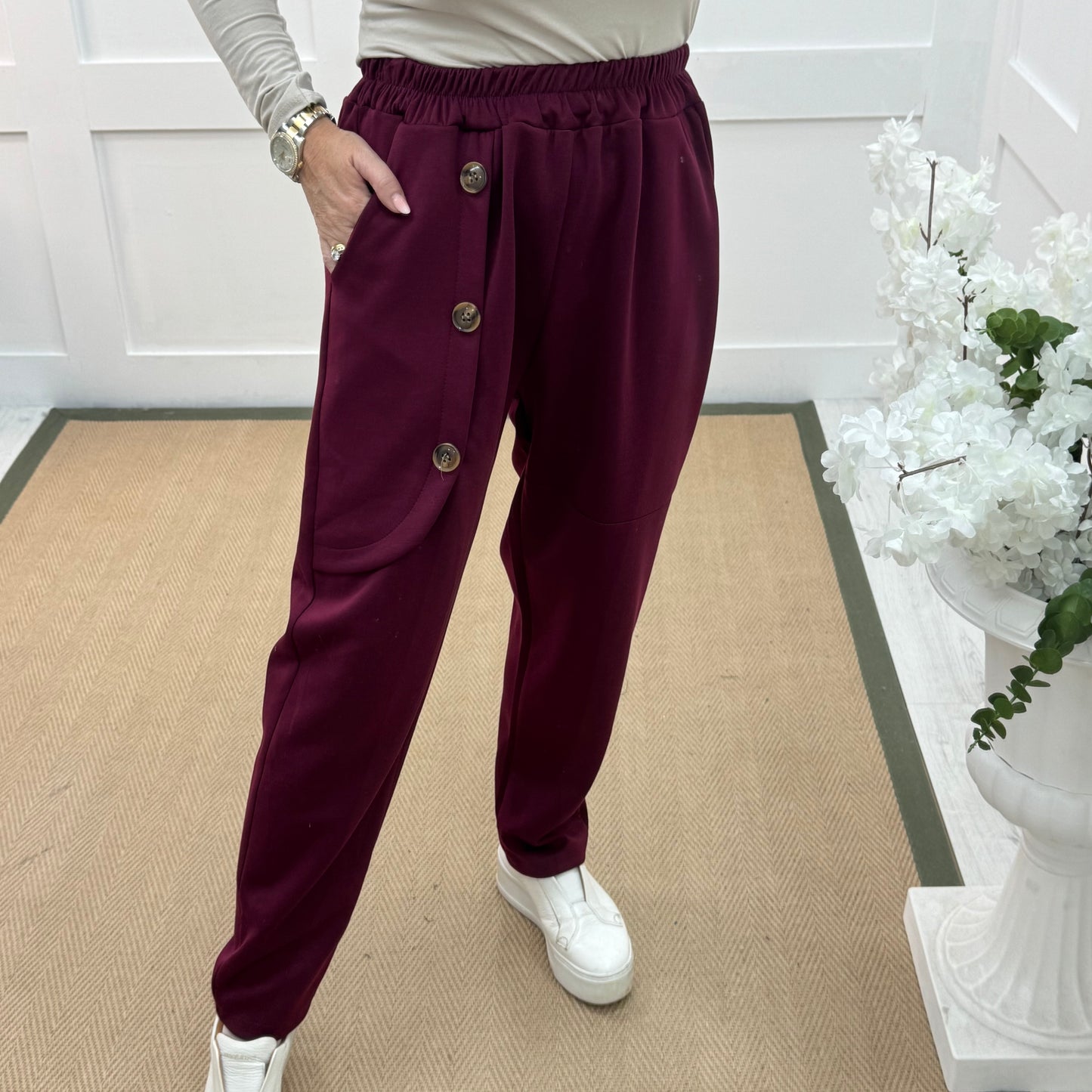 Monroe: Burgundy stretchy button trousers. One size: 12-18