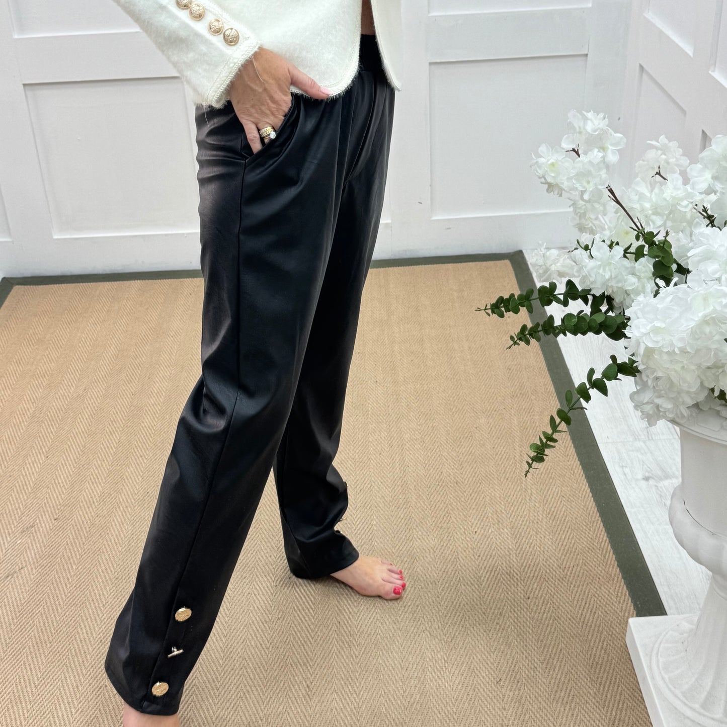 Tatum: Black faux leather button trousers. One size: 14-18