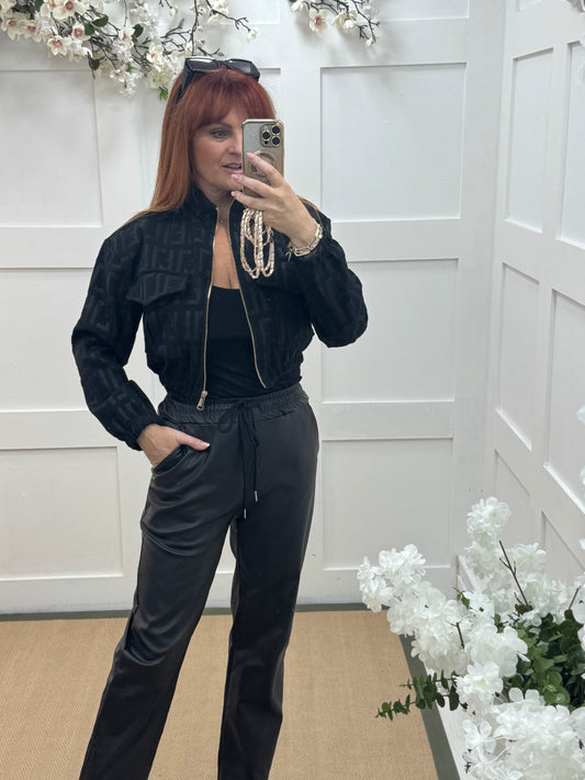 Quinn: Black faux leather trousers. One size: 10-14