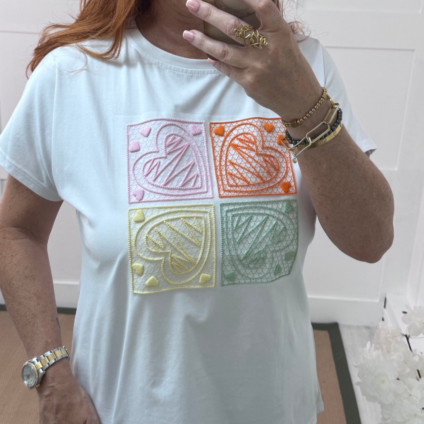 Sophie: White embroidered orange heart T shirt. One size 14-18