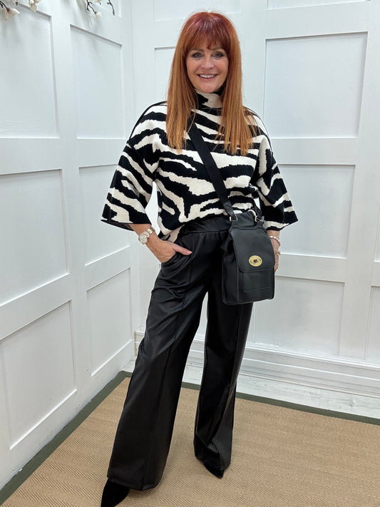 Tabatha: Black faux leather trousers. One size: 12-16