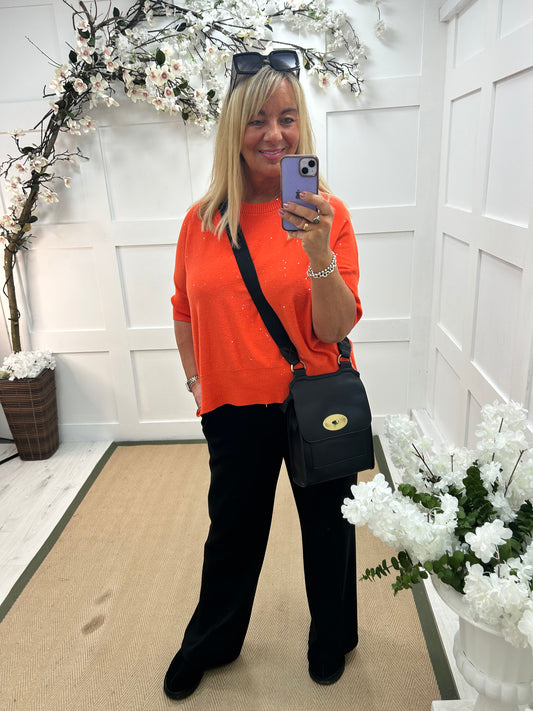 Josie: Orange short sleeve sparkle top. One Sz: 12-18