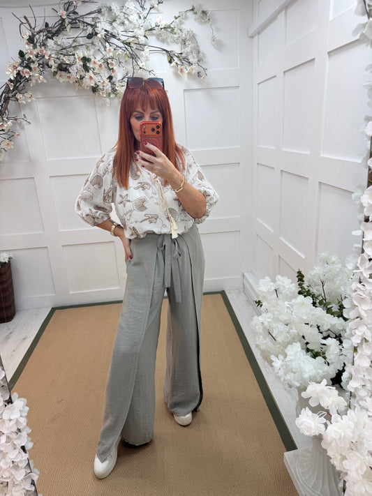 Eden: Stone tie waist wide leg trousers. One size: 10-16