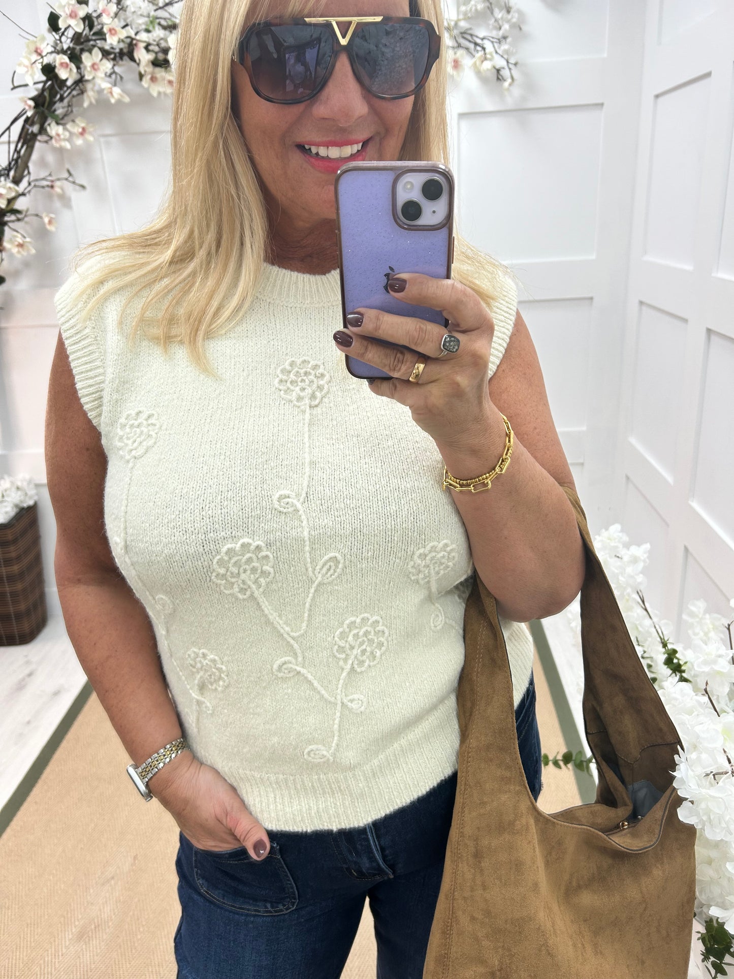 Larry: Cream sleeveless tank top with flower detail. One Sz: 12-18