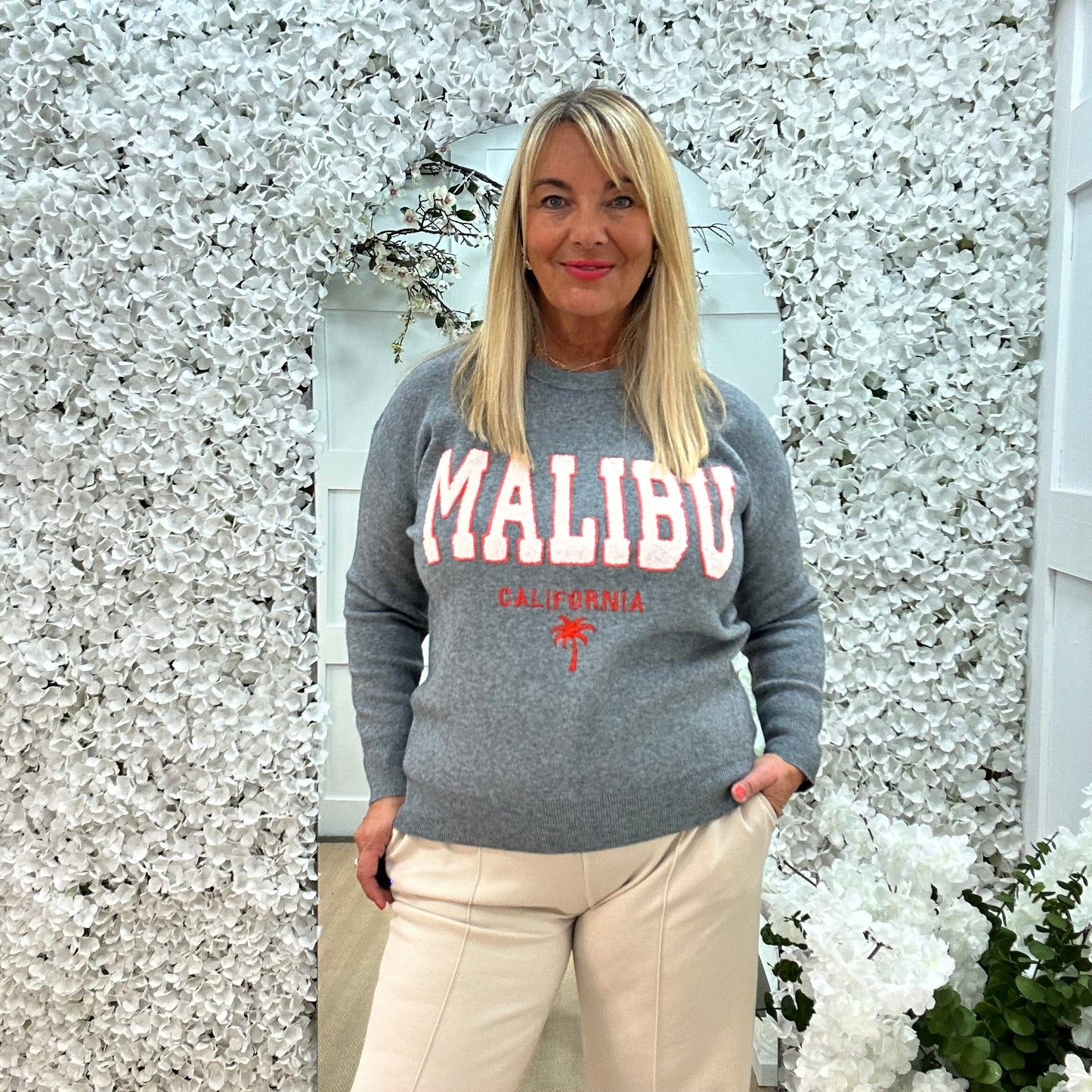 Melody: Grey textured MALIBU logo knitted top. One size 10-18