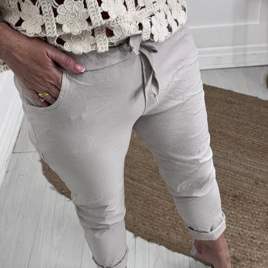 Marnie: Stretchy cream magic trousers with rear pockets. 3 Sizes: 10-22