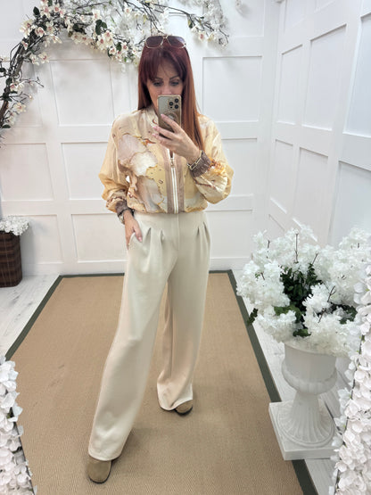 Tayla: Cream high waisted pleated wide leg trousers. One size: 10-16