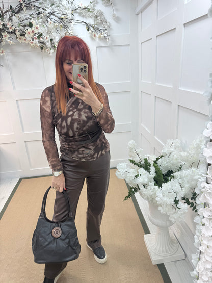 Pipa: Black slouchy big button shoulder bag.