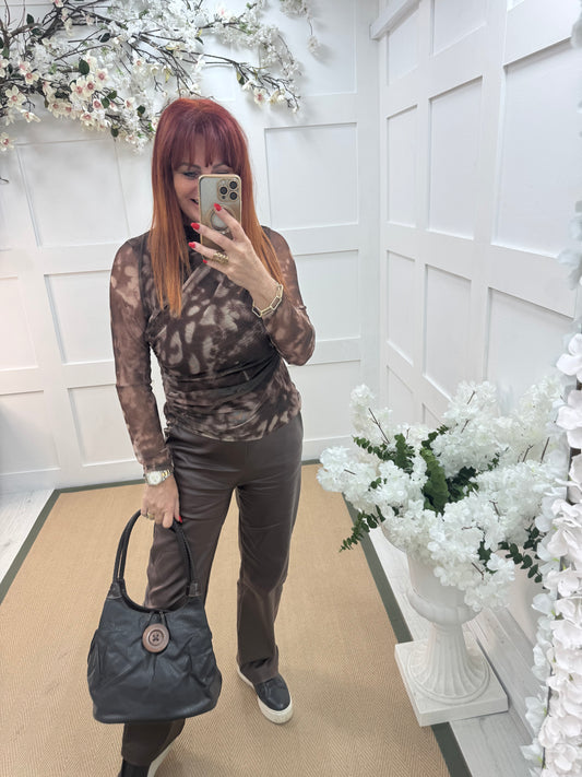 Pipa: Black slouchy big button shoulder bag.