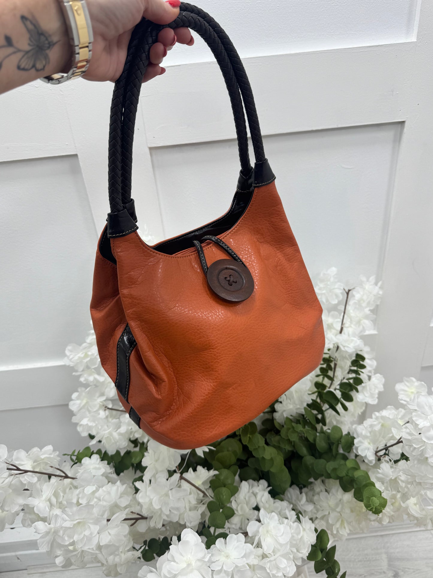 Pipa: Orange slouchy big button shoulder bag.