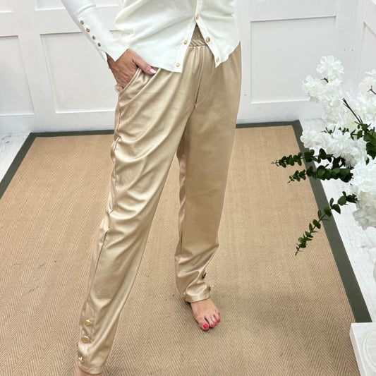 Tatum: Gold faux leather button trousers. One size: 14-18