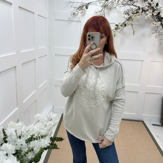 Sara: Cream hooded embossed compass top. One size: 12-18