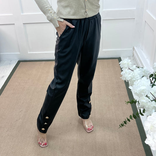 Tatum: Black faux leather button trousers. One size: 14-18