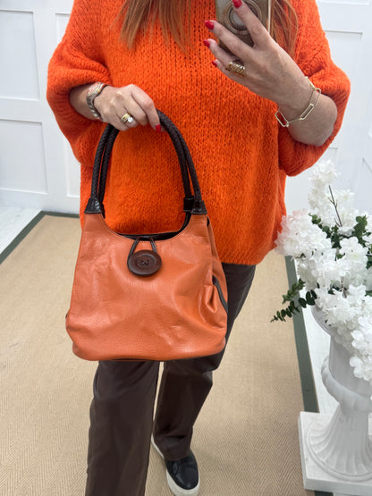 Pipa: Orange slouchy big button shoulder bag.