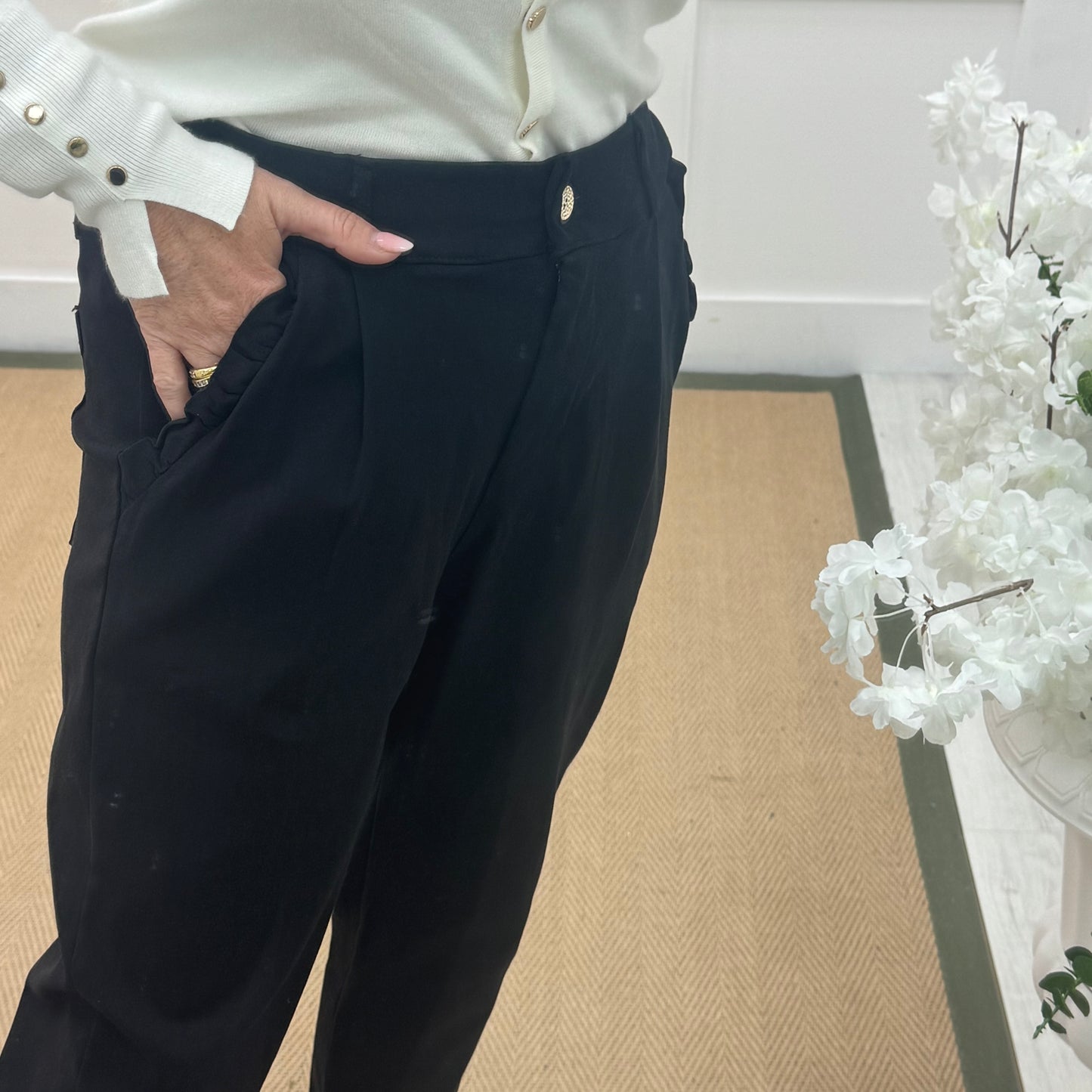 Mandi: Black stretchy frill pocket magic trousers with rear pockets. One Size: 14-20
