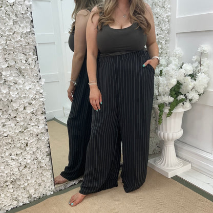 Storm: Black pinstripe wide leg trousers. One size: 16-22