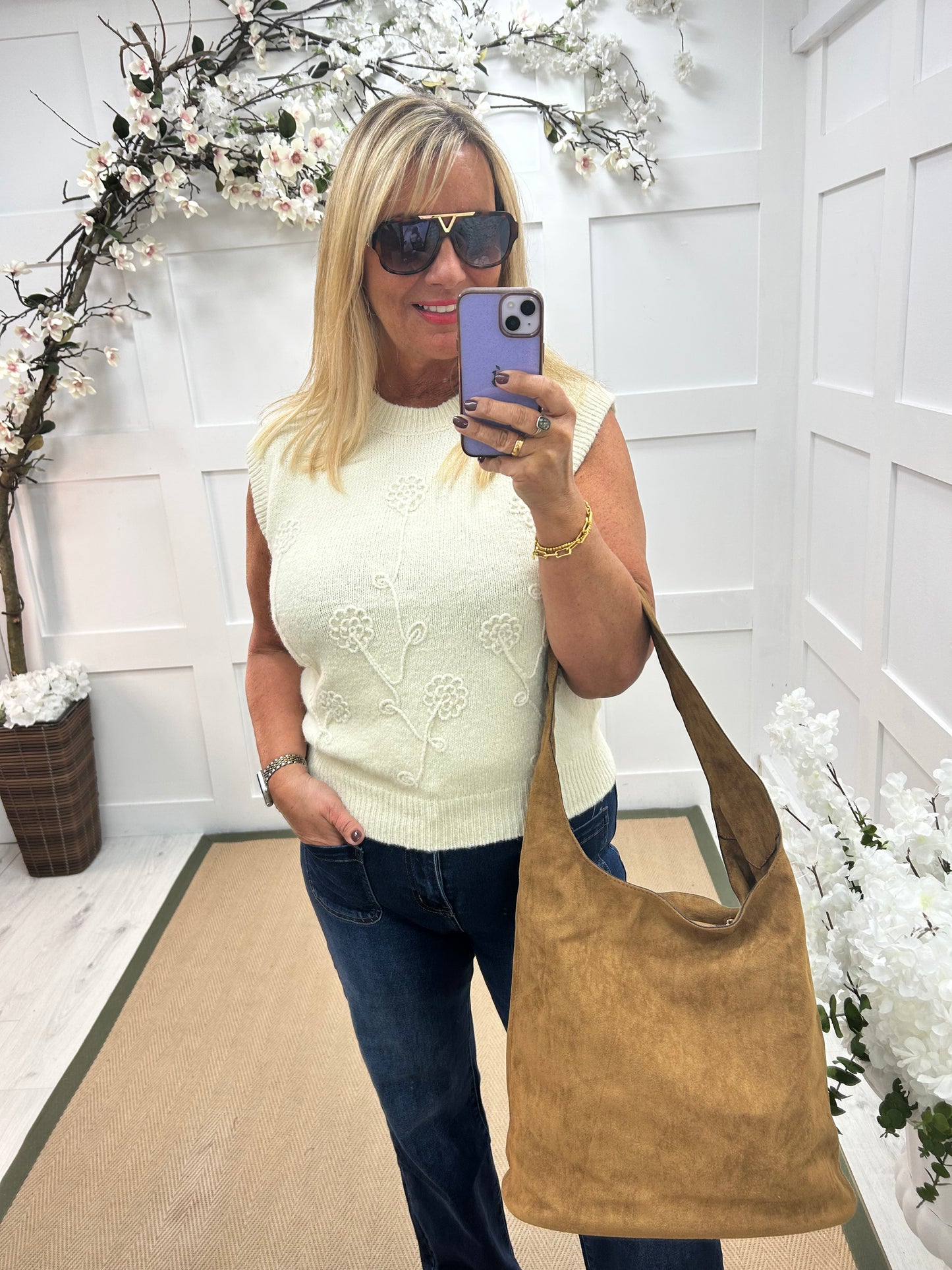 Larry: Cream sleeveless tank top with flower detail. One Sz: 12-18