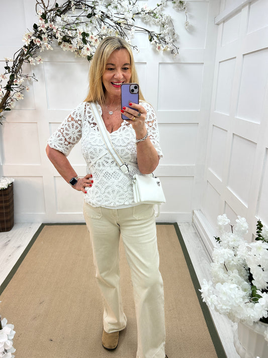 Ellie: White V neck short sleeved floral crochet top. One size: 10-16