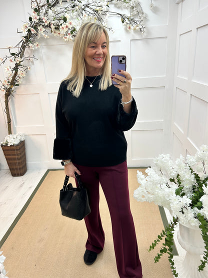 Coco: Black faux fur cuff knitted top. One size: 14-18