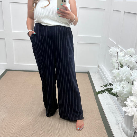 Storm: Navy pinstripe wide leg trousers. One size: 16-22