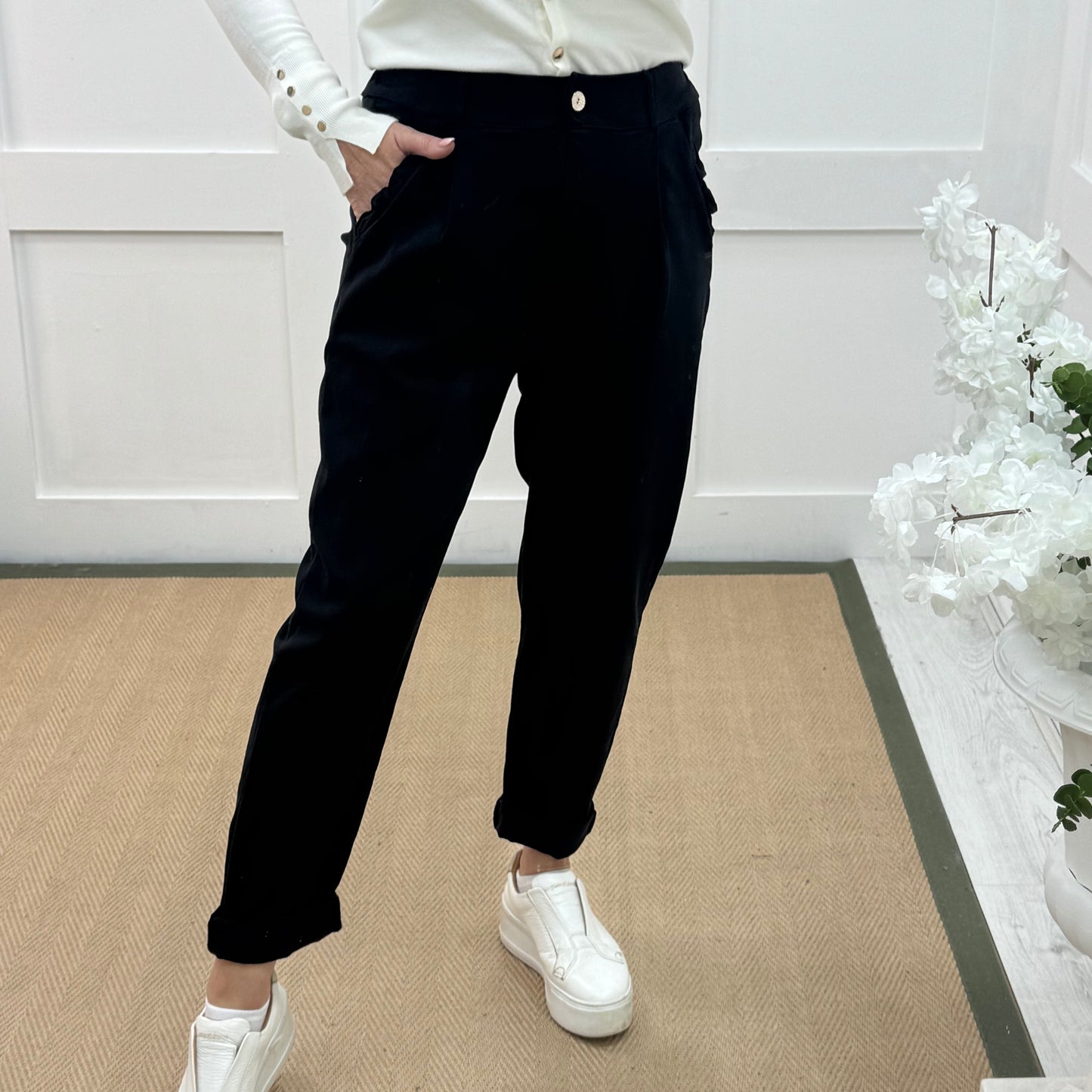 Mandi: Black stretchy frill pocket magic trousers with rear pockets. One Size: 14-20