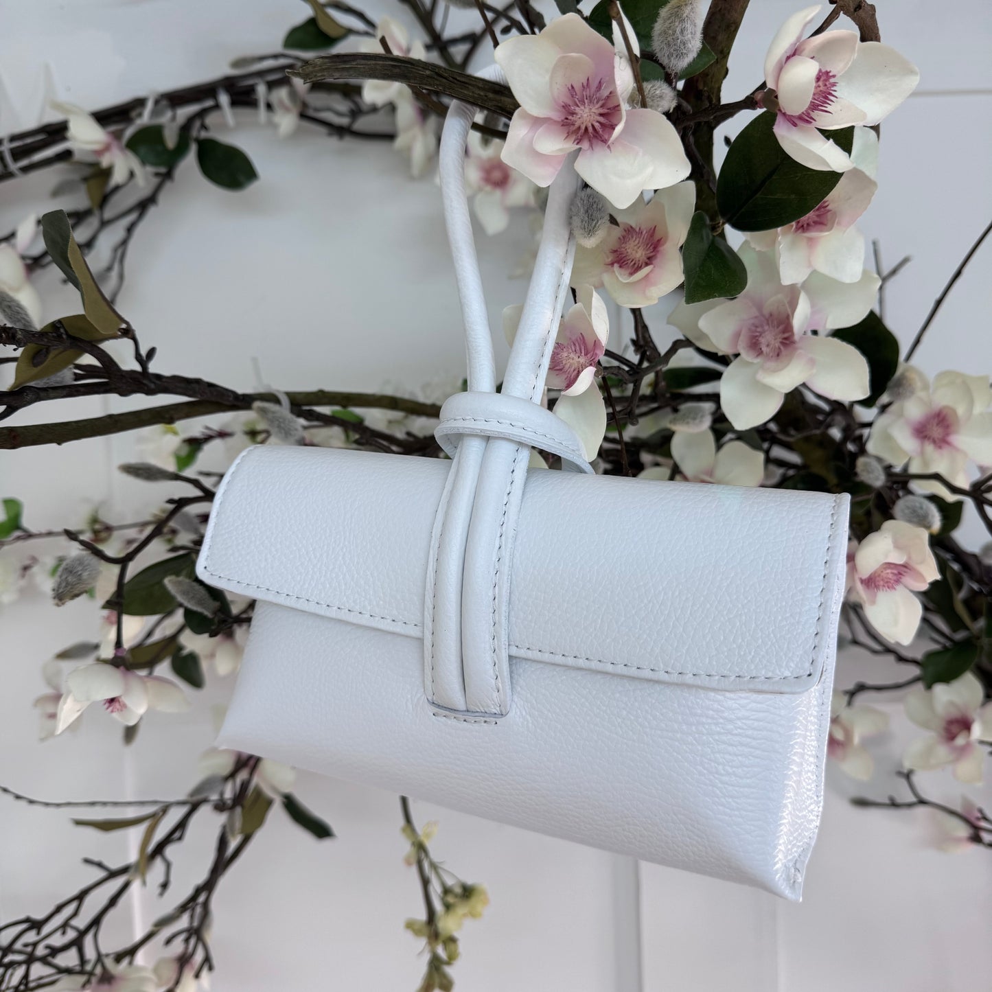 Alexis: White leather loop handle cross body/clutch bag.