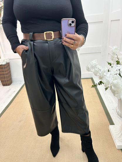 Allegra: Black 3/4 faux leather belted trousers. One size: 14-18