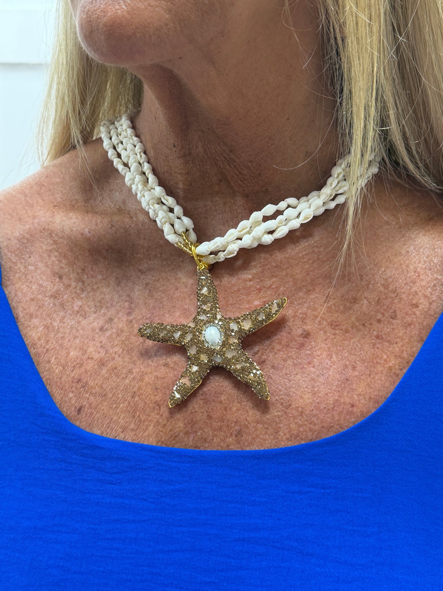 Starri: White & gold beaded starfish and shell statement necklace.