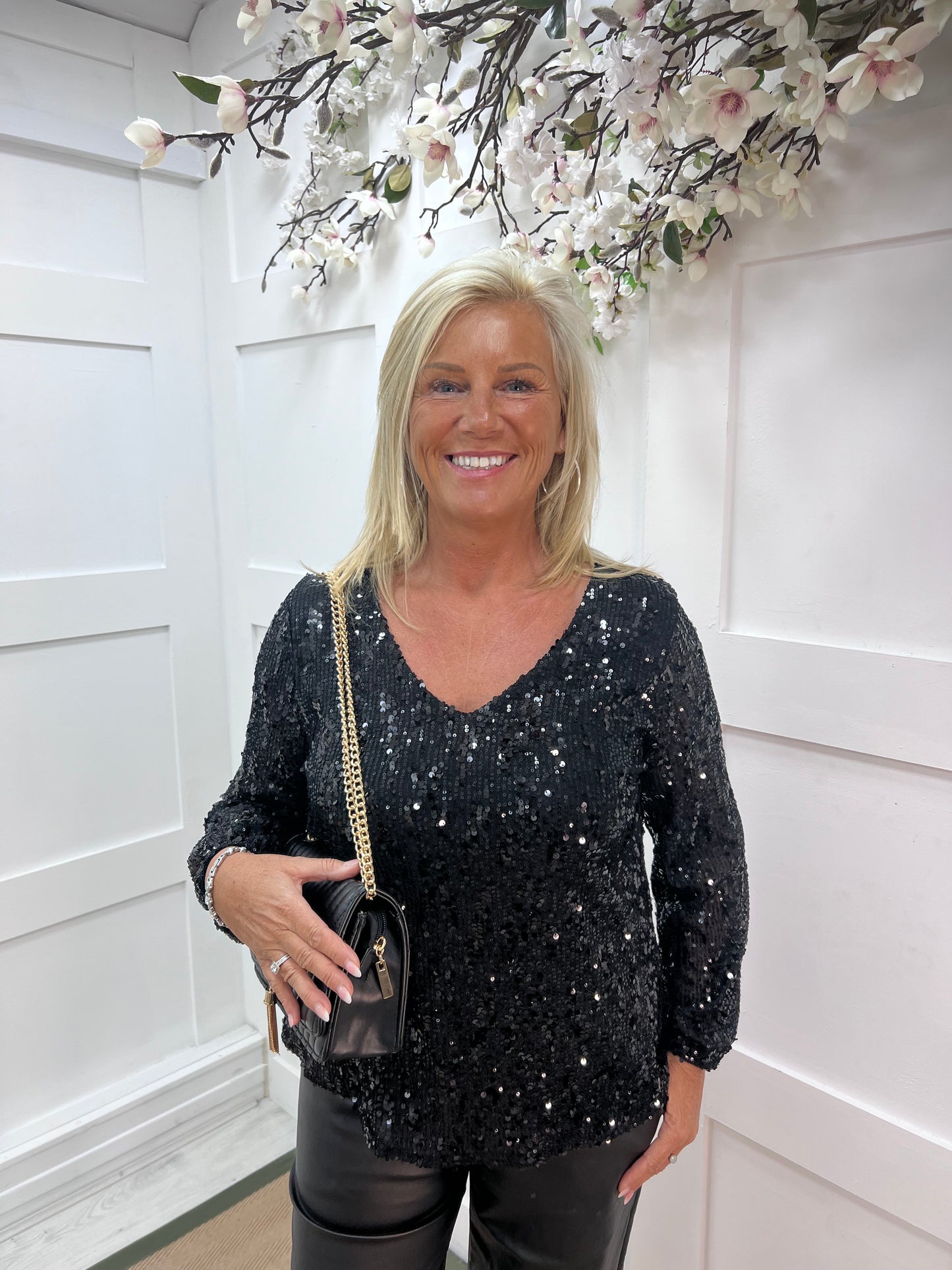 Sutton: Black v-neck sequin top. One size: 12-16