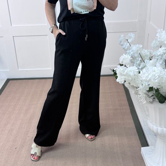 Trudy: Black stretchy wide leg pocket trousers. 2 sizes