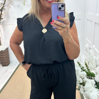 Drew: Black V neck button top. One size: 14-20